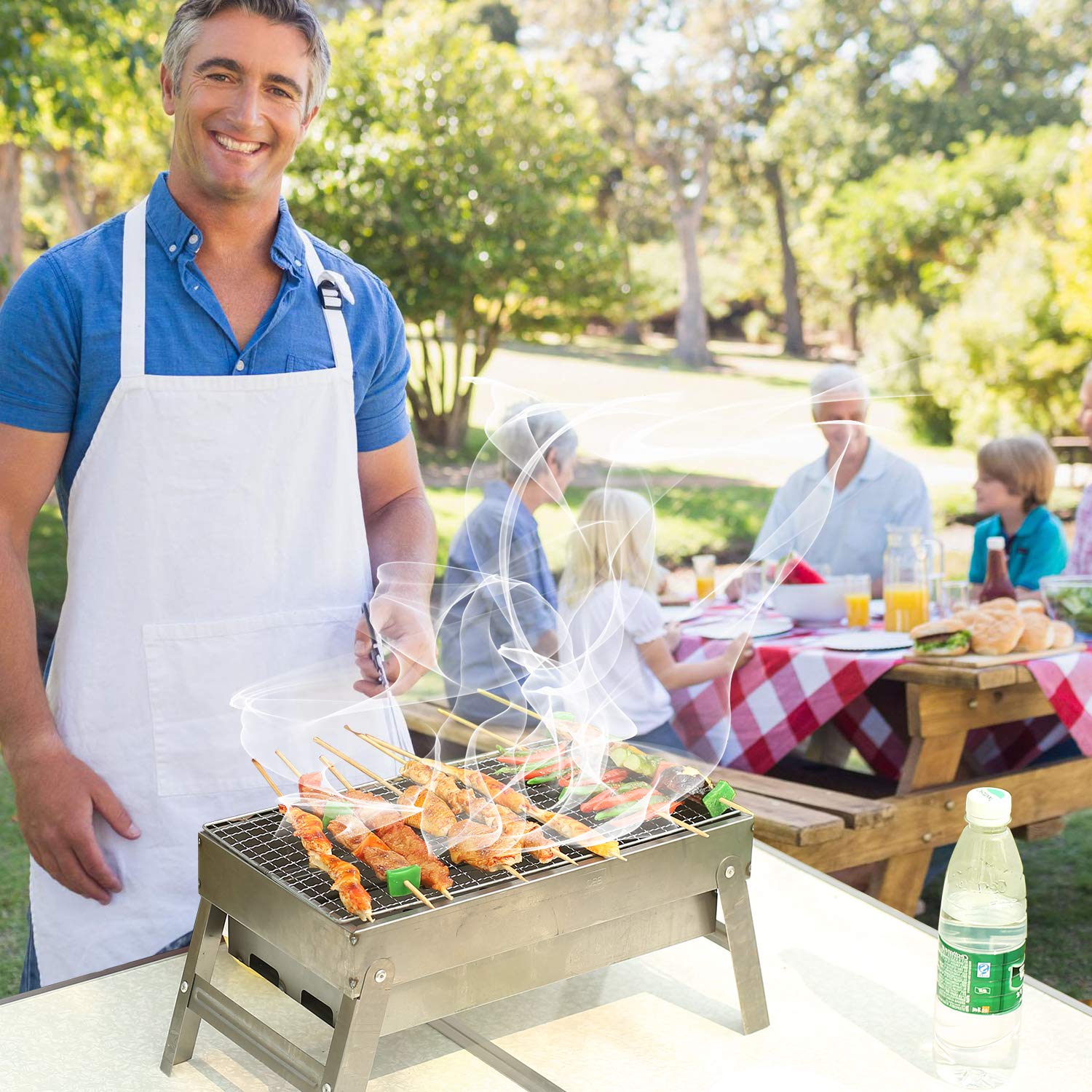 REDCAMP portable charcoal grill used for an outdoor family barbecue